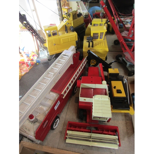 7374 - Three Tonka pressed tin toys to include Mighty Crane, T-6 Bulldozer and Fire Engine together with an... 