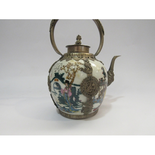 4231 - A reproduction eastern ceramic and metal teapot decorated with women in garden scenes and with scrip... 