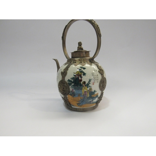 4231 - A reproduction eastern ceramic and metal teapot decorated with women in garden scenes and with scrip... 