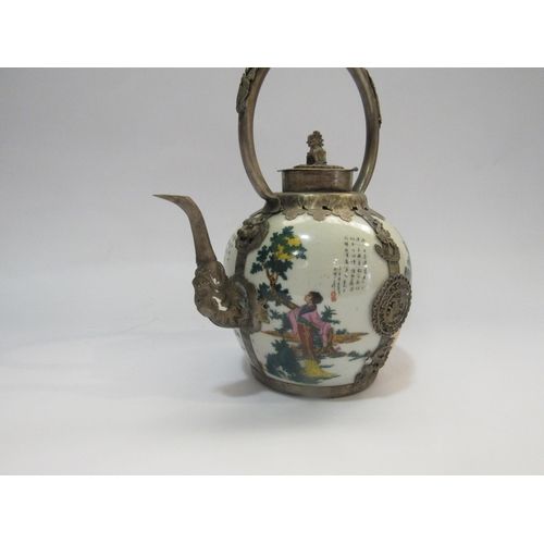 4231 - A reproduction eastern ceramic and metal teapot decorated with women in garden scenes and with scrip... 