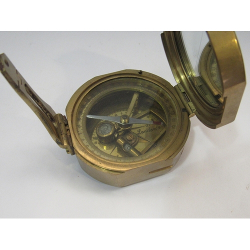 4269 - A metal globe ornament together with a brass compass