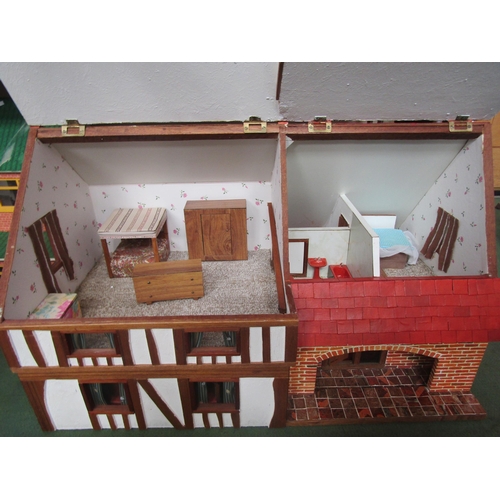 7127 - A two storey dolls house as a thatched farmhouse, 48cm tall x 77.5cm wide x 48cm deep        (E) £20... 