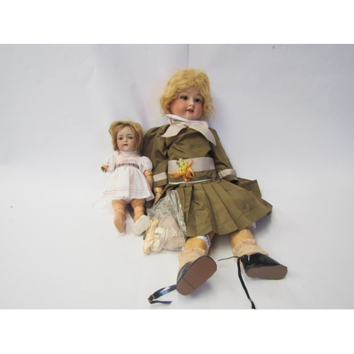 7129 - An Armand Marseille bisque head girl doll on jointed composition body, 64cm tall, and a Simon & Halb... 