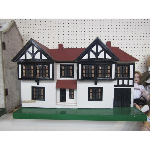 7131 - A Tri-ang style two storey painted wooden two storey dolls house with metal windows, with assorted f... 