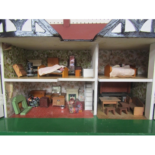 7131 - A Tri-ang style two storey painted wooden two storey dolls house with metal windows, with assorted f... 