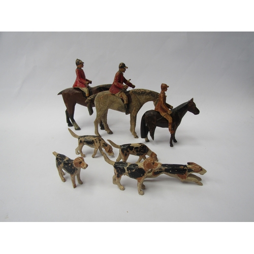 7174 - An early 20th Century painted and carved wooden set of fox hunting figures comprising three horses a... 