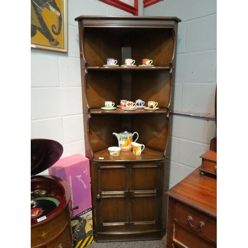 1068 - An Ercol full height corner cabinet with shelving over cupboard base, 183cm high x 75cm wide