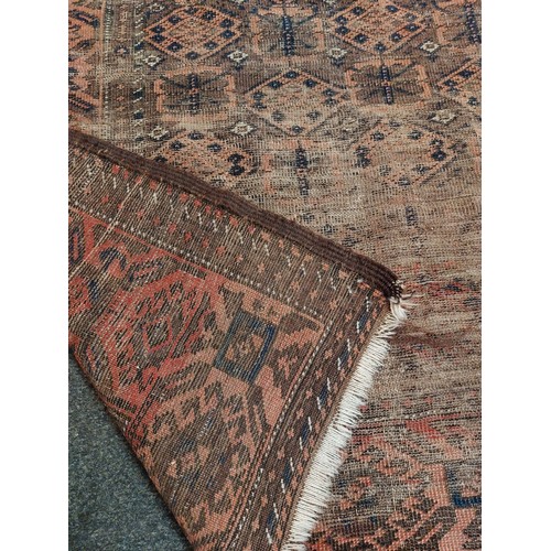 1049 - An Afghan kilim rug with red ground and multiple rows of guls, 178cm x 110cm, tasselled fringe.