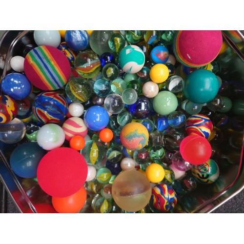 7071 - A tin of assorted marbles and balls