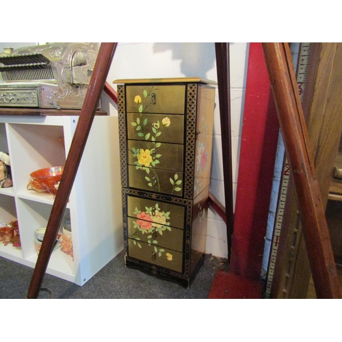 1002 - A chinoiserie lacquered six drawer floor-standing jewellery cabinet with lift top and hinged side do... 