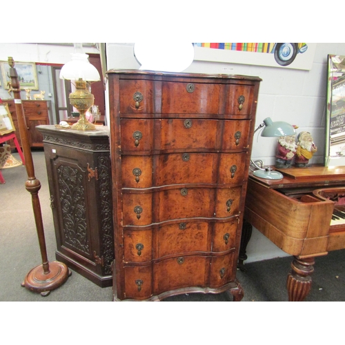 1023 - An early 20th Century mahogany and burr walnut veneered chest of six drawers with shaped front on ca... 