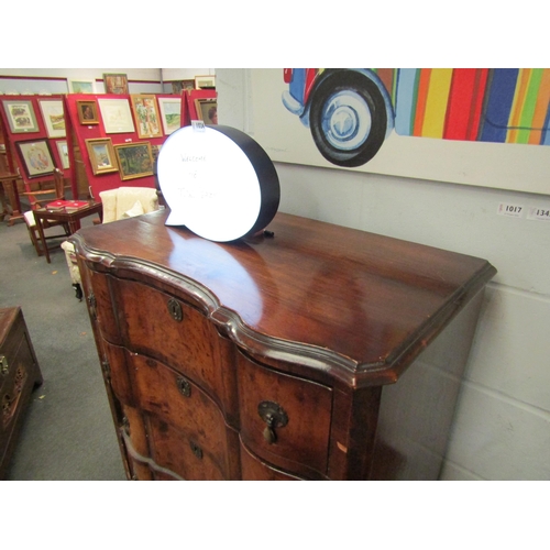 1023 - An early 20th Century mahogany and burr walnut veneered chest of six drawers with shaped front on ca... 