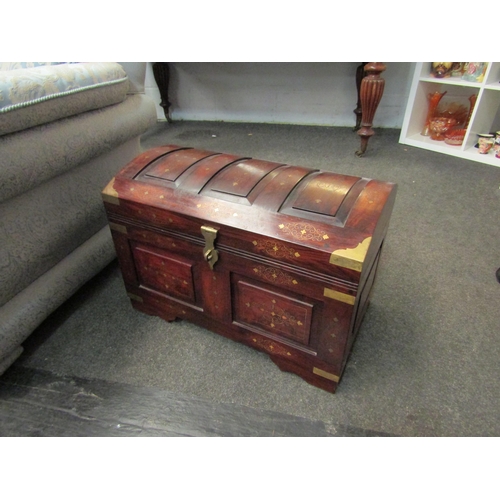 1026 - A Middle Eastern hardwood domed chest with brass inlaid decoration