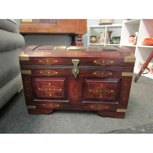 1026 - A Middle Eastern hardwood domed chest with brass inlaid decoration