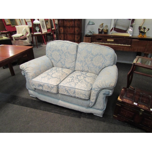 1027 - A classic style two seater sofa, rope trim, loose cushions, pale blue floral upholstery, Life Style ... 