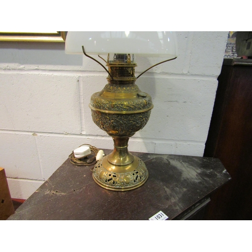 1030 - A brass oil lamp converted to electric, a/f, chip to shade