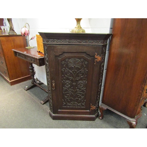 1031 - A Victorian oak corner cupboard with foliate and Tudor Rose carved door, wavy shelved interior, 111c... 