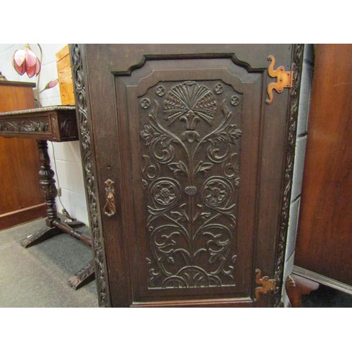 1031 - A Victorian oak corner cupboard with foliate and Tudor Rose carved door, wavy shelved interior, 111c... 