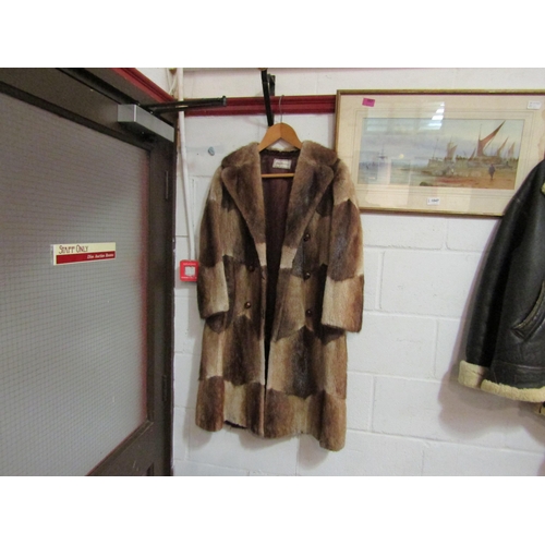 1048 - A 1960's early 70's zig zag cut fur coat with wood and brass buttons, Derbers label, front hem a/f