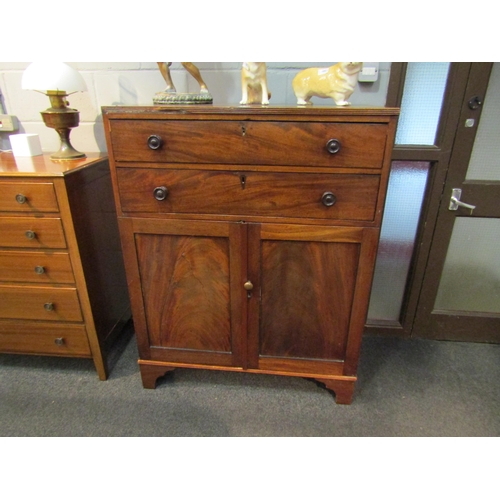 1054 - An early Victorian mahogany cabinet, the two drawers over two cupboard doors, bracket supports, some... 