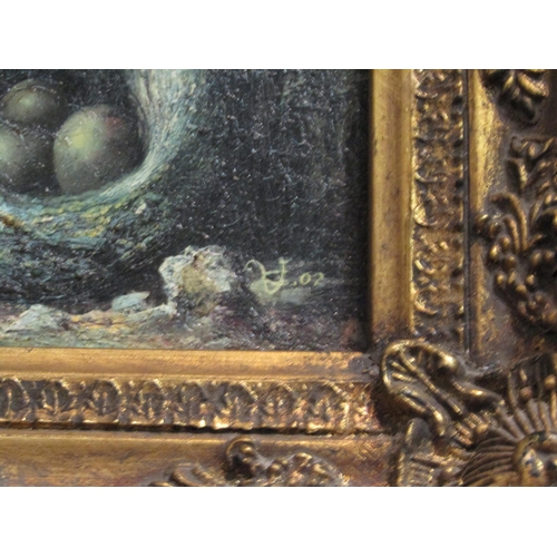 1063 - Two ornately gilt framed oleographs depicting eggs in nests, 19cm x 24cm image size