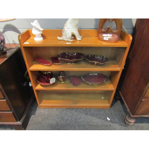 1088 - A 1960s oak bookcase with three sliding glass doors, 83cm high x 91cm wide x 22cm deep