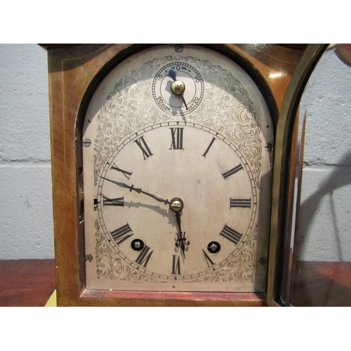 1092 - A chiming bracket clock with bevel edged glass door on brass feet, 27cm high