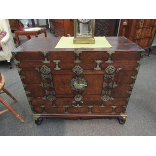 1171 - A Korean wooden cabinet with veneered front, two front doors, metal trims, on matching stand, 78cm h... 