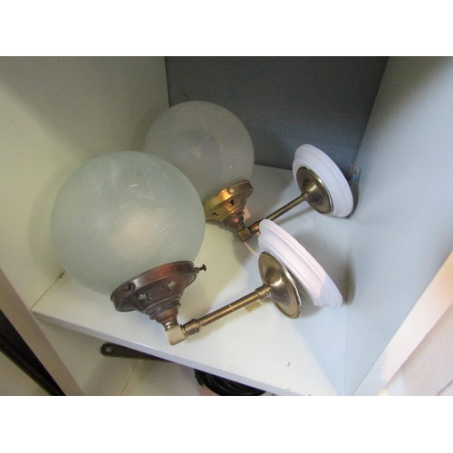 1283 - A pair of brass wall lights with frosted spherical shades