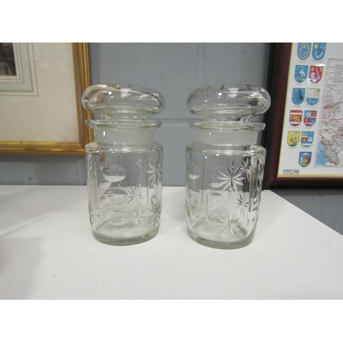 1300 - A pair of Edwardian cut glass jars, 15cm tall