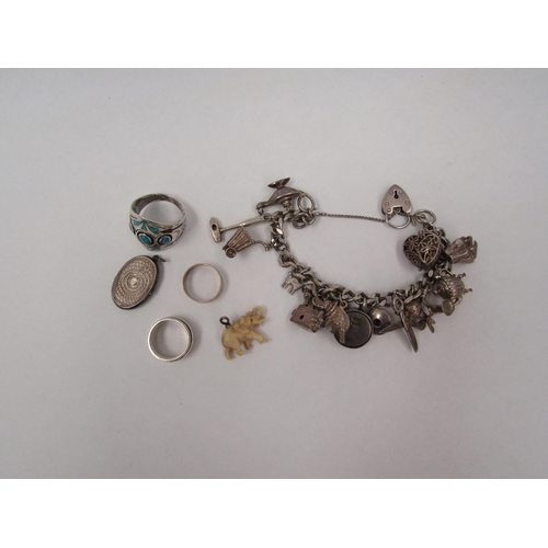 1333 - A silver charm bracelet hung with various charms including elephant, teapot, Mr Whippy '99, with thr... 