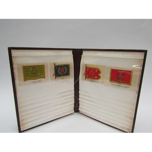 1380 - An album containing 30 regimental badges and flags printed on silk