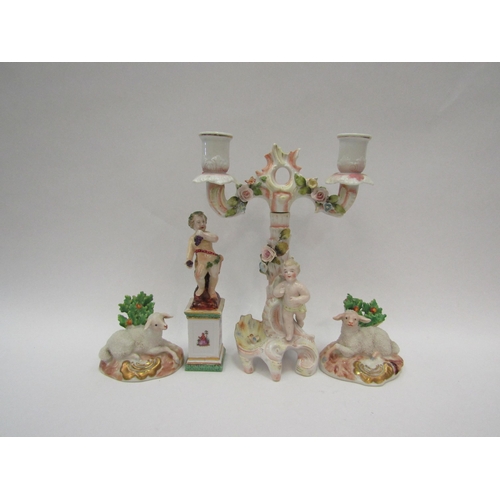 1390 - A pair of porcelain lambs with gold anchor mark to base, a putti holding grapes and standing atop a ... 