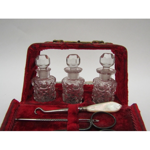 1391 - A Victorian velvet lined lady’s vanity vase with sewing accoutrements and three scent bottles, velve... 