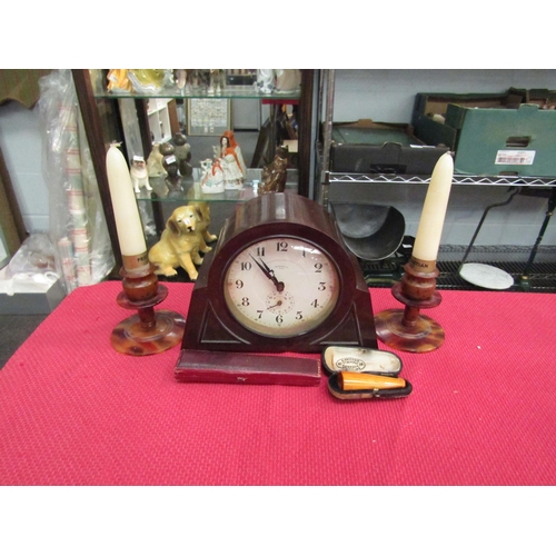 1530 - A bakelite Ingersol mantle clock, a pair of bakelite candlesticks of squat form and two cheroot hold... 