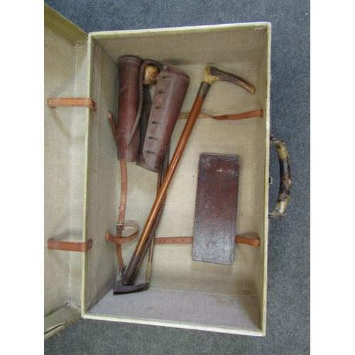 1562 - A vintage suitcase containing riding crops, leather gaiters, etc