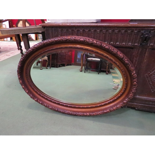 4012 - An oval ornate frame copperized wall hanging mirror, 55cm x 83cm total