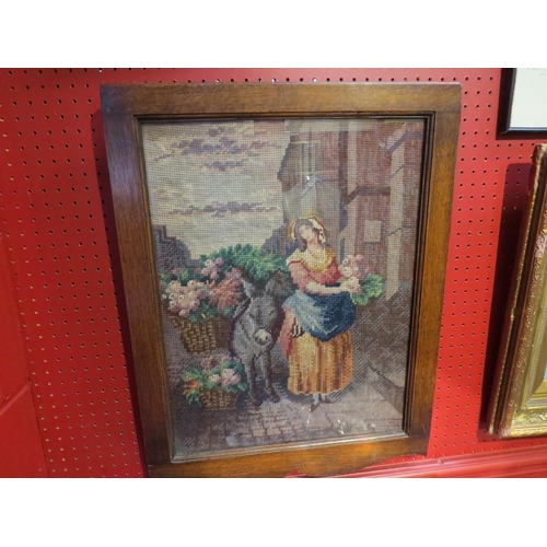 4098 - A vintage oak framed Irish woolwork picture from Co. Wexford of a woman standing beside a donkey lad... 