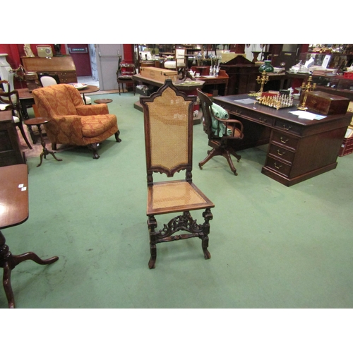 4181 - A walnut hall chair carved in Carolean style pierced with fretwork panel to front, cane work seat pa... 