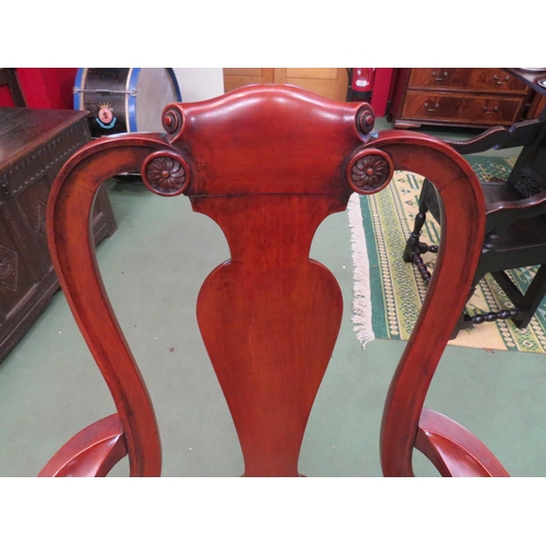 4200 - A George II revival walnut armchair the vase shape central splat over outswept scroll arms and needl... 