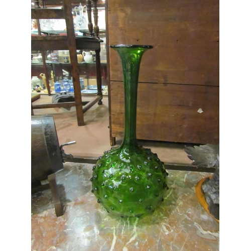 4298 - A late 20th Century art glass vase in green with bulbous base and protruding prunts, 42cm high