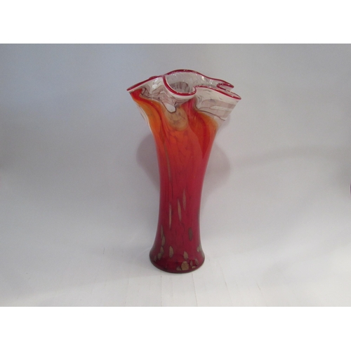 4399 - A late 20th Century art glass vase in red with gold foil inclusions and waved rim, 36cm high