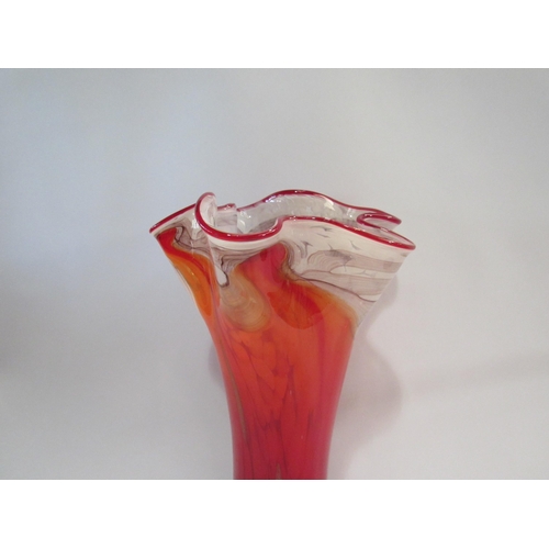 4399 - A late 20th Century art glass vase in red with gold foil inclusions and waved rim, 36cm high