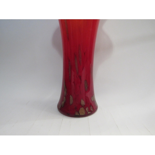 4399 - A late 20th Century art glass vase in red with gold foil inclusions and waved rim, 36cm high