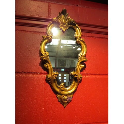 4109 - A George II revival gilt wood framed wall mirror with scroll leaf decoration, 50cm x 24cm total