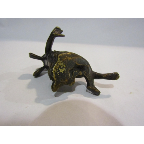 4327 - A bronze figure of a recumbent cherub, 5cm tall, 7cm long  (R)  £50