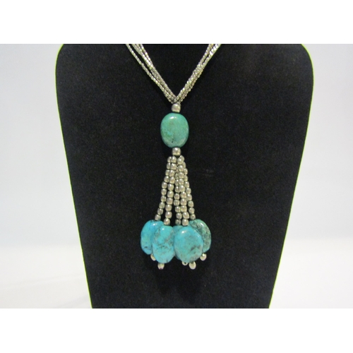 4332 - A white metal multi strand pendant necklace with turquoise droplets