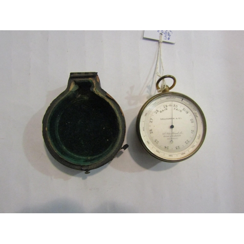 4383 - A brass cased pocket aneroid barometer, with altitude ring, by Callaghan & Co, London 6.5cm diameter... 