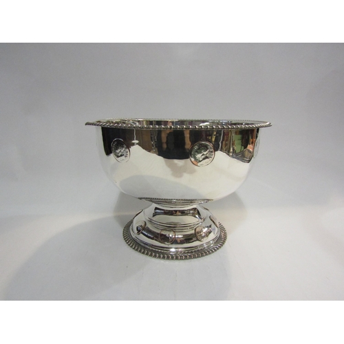 4404 - A white metal punch bowl inset with coin detail, gadrooned edge on pedestal base, 25cm diameter    (... 