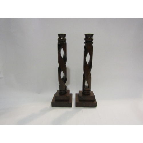 4420 - A pair of Arts & Crafts oak candlesticks possibly Glasgow school the turned sconces on a corkscrew s... 